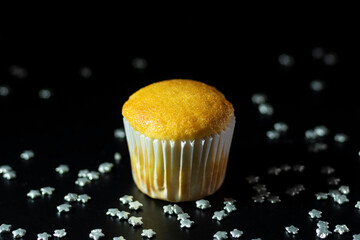 cupcakes or cupcakes with dulce de leche pastry cake and sprinkles on a black background