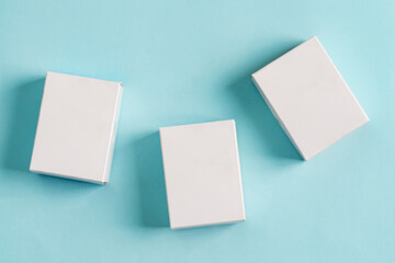 Set from three paper mock up boxes for packaging products and things on a pastel blue background.
