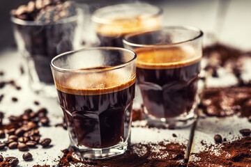 Black Turkish coffee in glass cups and spilled coffee beans