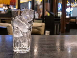 Ice cubes in a glass, 1 glass, placed on a black table, blur background