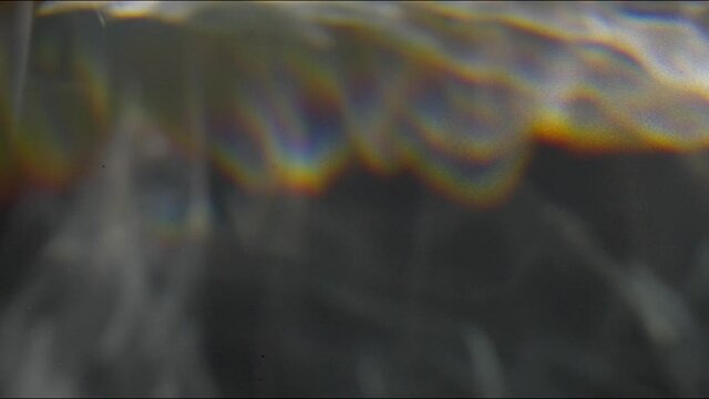 caustic water light effect with diffraction light rainbow on grey background