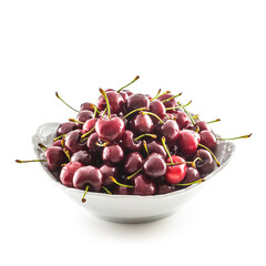 Sweet ripe cherries in bowl isolated on white background