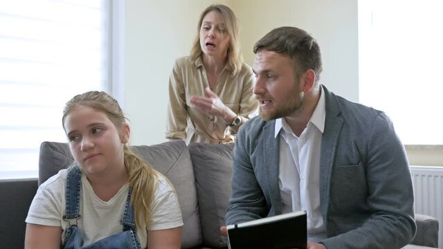 Problems of parenting in the family. Parents scolding teenage daughter for poor school performance. Father and mother scream at the girl. The child is demonstratively silent.