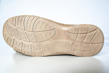 Men's beige leather shoes, models moccasins. Photographed close-up on a light background.