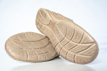 Men's beige leather shoes, models moccasins. Photographed close-up on a light background.