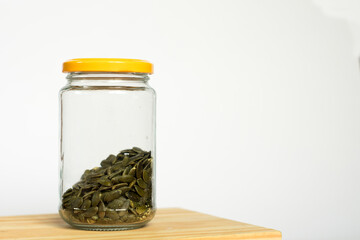 Pumpkin seeds in glass jar. 