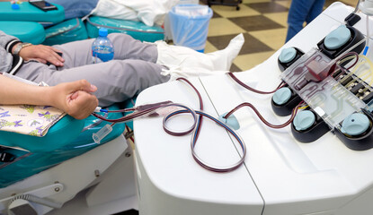 a donor in an armchair donating blood at hemotransfusion station