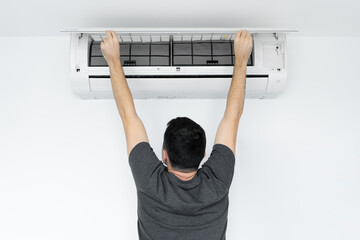 The guy cleans the filter of the home air conditioner from dust. Very dirty air conditioner filter....