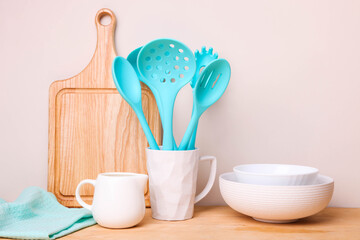 Fototapeta na wymiar Set of blue kitchen utensils in a ceramic cup and tableware
