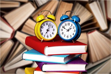 Collection of the old library book pile and alarm clocks