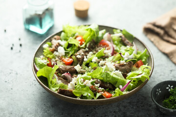 Green salad with beef steak and fresh cheese