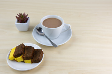 Breakfast with a cup of milk tea and layer cakes.