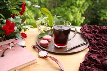 french pasta cake on a copper tray, pomegranate, cherry juice, fruit drink in a glass mug, women's watches, glasses, daily planner in garden, concept lifestyle, breakfast on summer terrace, seasonal