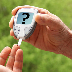 male hands closeup, a man does a nature test with a glucometer, medical concept, blood glucose...