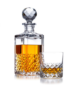 A Half Full Crystal Whisky Decanter, And Crystal Glass, With Golden Whisky, Shot On White