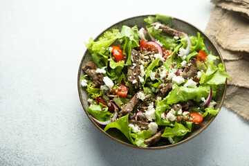 Green salad with beef steak and fresh cheese