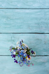 spring flowers on turquoise wooden surface