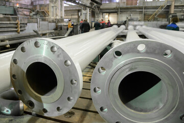 new steel pipes are lying on the floor in the shop