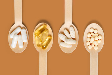 Multivitamin supplements on wooden spoons
