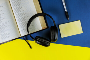 Holy Bible with headphones - symbol of listening to the Word of God