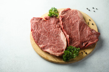 Raw beef steak on a wooden desk
