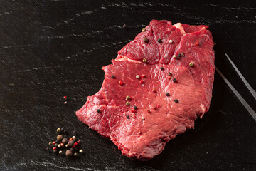 Steak raw. Barbecue Rib Eye Steak or rump steak on black stone