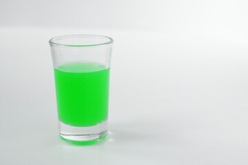 Glass of green alcohol. Shot of green in a glass.