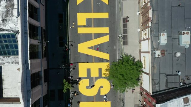 rising and spinning reveal of BLM sign on Fulton St. in Bed Stuy Brooklyn