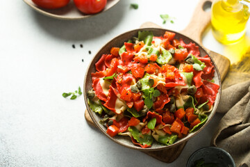 Multi-colored Italian pasta with capers and tomatoes