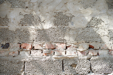 Wall background of expanded clay concrete blocks, bricks and plaster