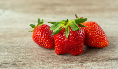 fresh strawberries on a wooden background. bright and juicy berries. source of useful substances and vitamins.
