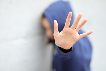 girl with hoodie trying to protect herself from aggression