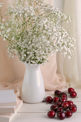 decorated with a simple bouquet of flowers and cherries
