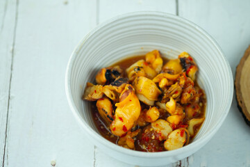 Grilled squid mix with spicy seafood sauce in bowl