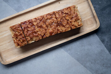 The square slice of toffee cake with cashew nut