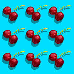 Seamless cherry texture on a turquoise background with a hard shadow