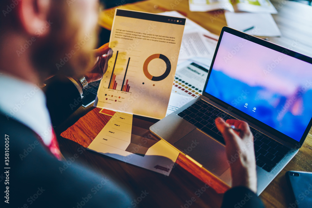 Poster cropped image of skilled financial expert using modern laptop computer for checking diagram data onl