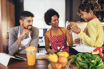 Happy family preparing healthy food in kitchen together