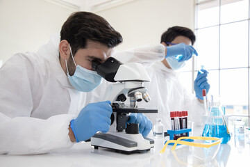 Doctor carried a blood vessel that was a plasma sample of a patient infected with the coronavirus or Covid-19. An experiment to produce a vaccine for the treatment of disease in an aseptic lab. 