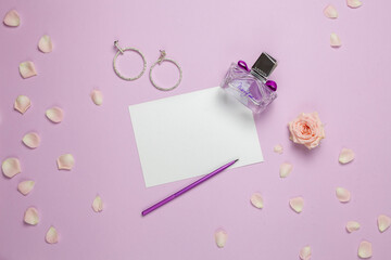 Ping background with perfume and accessories, top view
