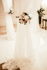 fragment of a wedding arch at a ceremony decorated with flowers.