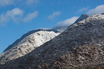 Winter mountain, snow capped and cloud covered
