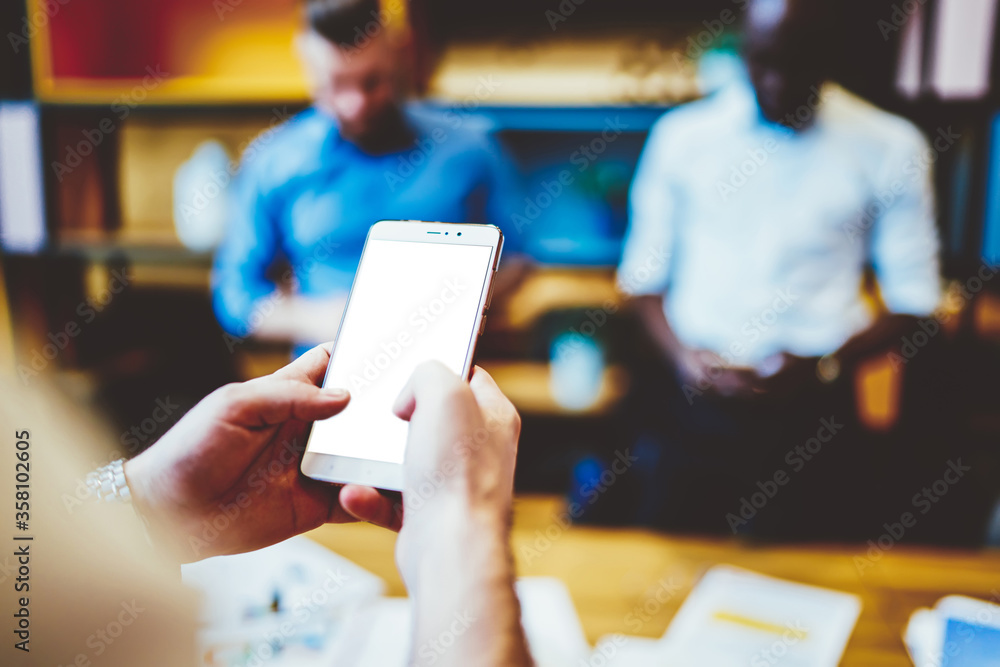 Poster cropped view of hands typing text and installing app on modern smartphone with blank screen for your