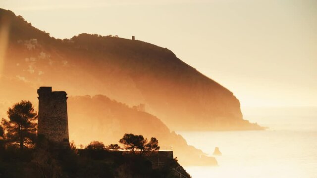 Clouds moving over Torre Del Pino, tower on cliffs of Maro Cerro Gordo Natural Park, near Maro and Nerja, Malaga province, Costa Del Sol, Andalusia, Spain. Time lapse

