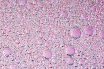oil with bubbles on coral background. Pink Abstract space background. Soft selective focus. macro of oil drops on water surface. copy space. air bubbles in water