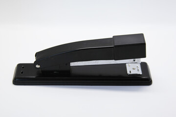 Manual stapler, a tool that allows you to staple a sheet of paper or cardboard through a piece of...