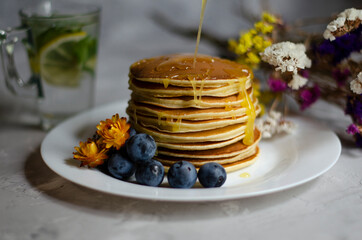 pancakes with honey, berries and cold mojito