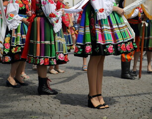 woman in traditional folk clothes costumes from Lowicz region in Poland while join Corpus Christi procession