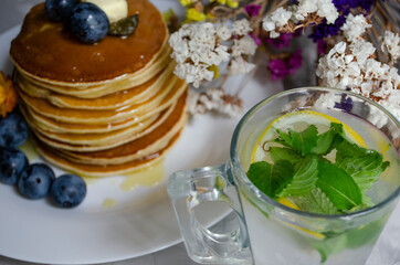 pancakes with honey, berries and cold mojito
