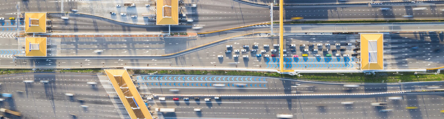 Car traffic transportation on multiple lanes highway road and toll collection gate, drone aerial...